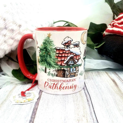 Personalised Christmas ceramic mug with colourful Christmas design, custom place name and red handle.