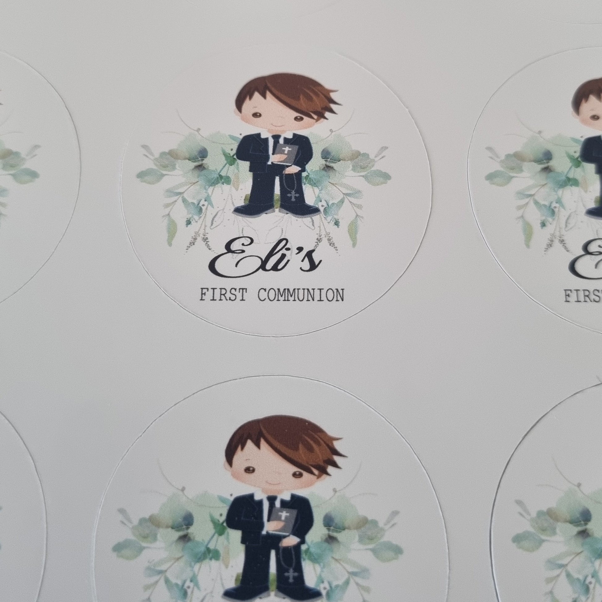 Photo showing scale of personalised First Communion sticker sheets held in hand, custom name and date printed stickers