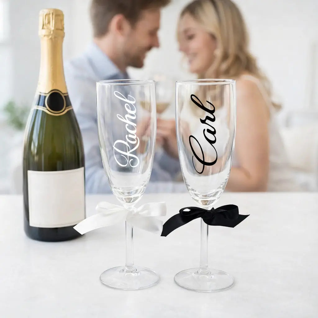 Personalised champagne flutes for an engaged or wedding couple with custom names, tied with ribbon, Irish made personalised gift