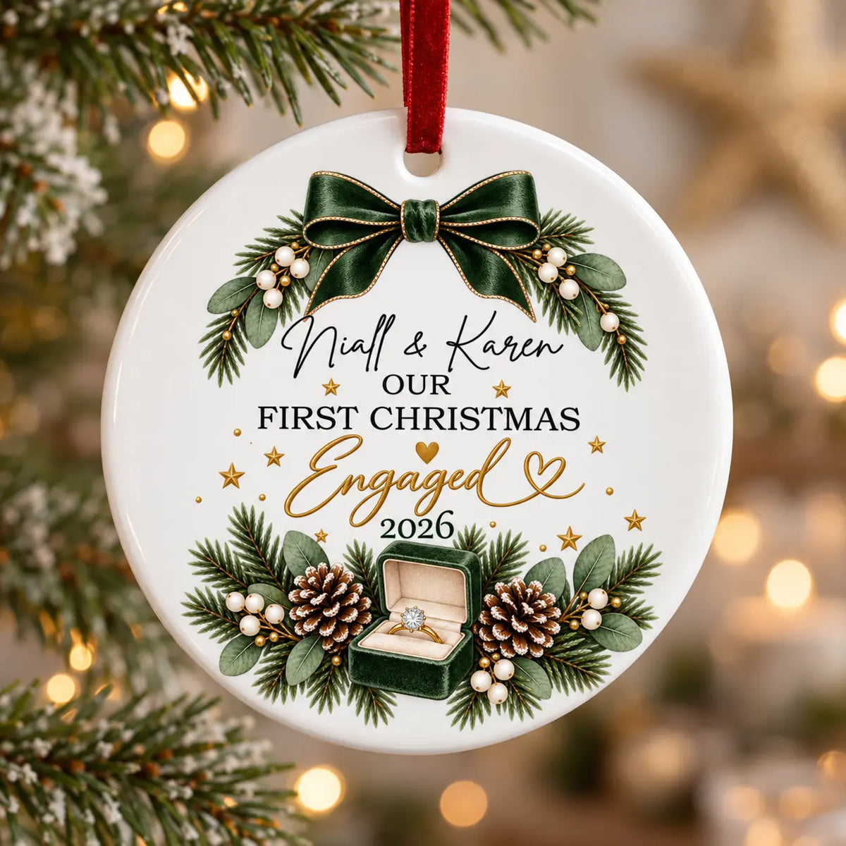 Personalised First Christmas engaged ceramic decoration with couple’s names, green festive bow, engagement ring and red velvet ribbon