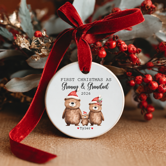 Personalised First Christmas as Granny & Grandad 2026 ceramic Christmas decoration featuring three cute bears in Santa hats, the grandchild's name and a red velvet ribbon.