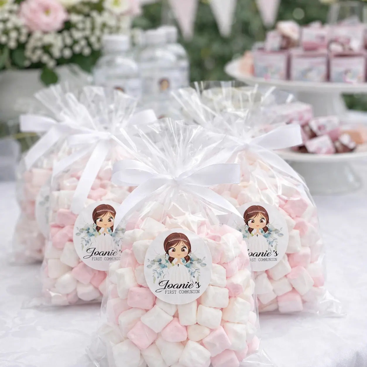 Personalised first communion stickers shown on a clear bag of sweets at a first communion party. 