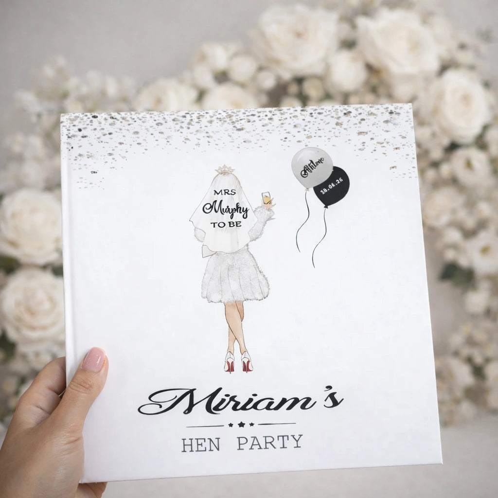 Personalised hen party keepsake photo book with bride illustration cover held against soft neutral floral background, hen party bride to be gift idea