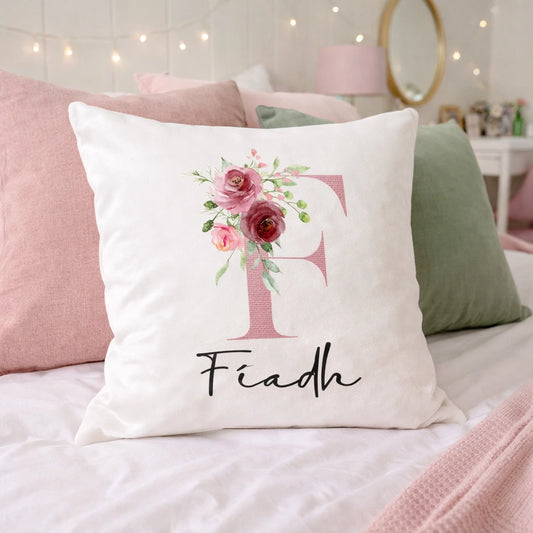 personalised white velvet cushion with floral initial F and name Fiadh on a pink and green teenage bedroom bed Ireland