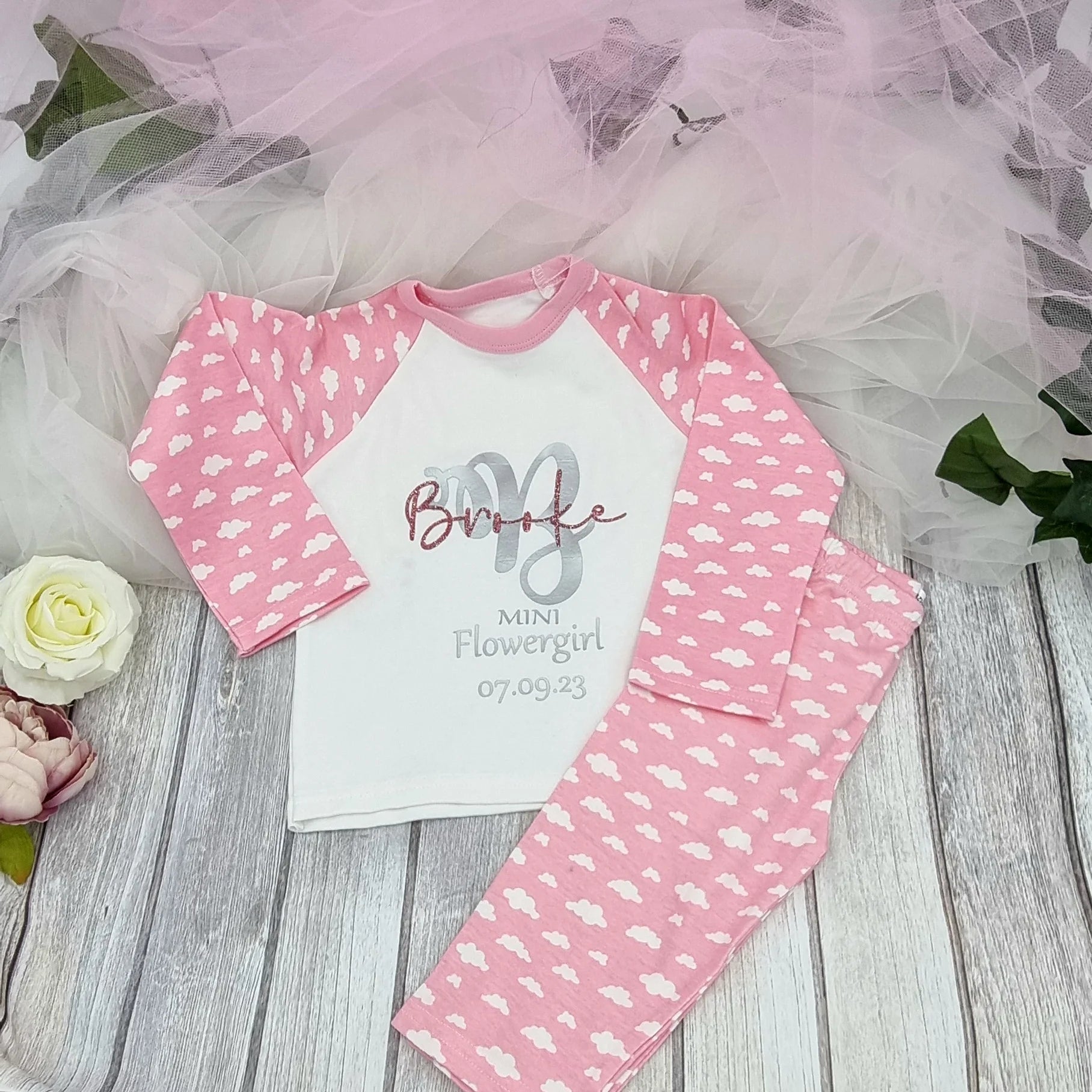 Personalised pink cloud print flowergirl pyjamas with custom name and wedding date, designed, printed and finished in Ireland by HanaLee Studios.