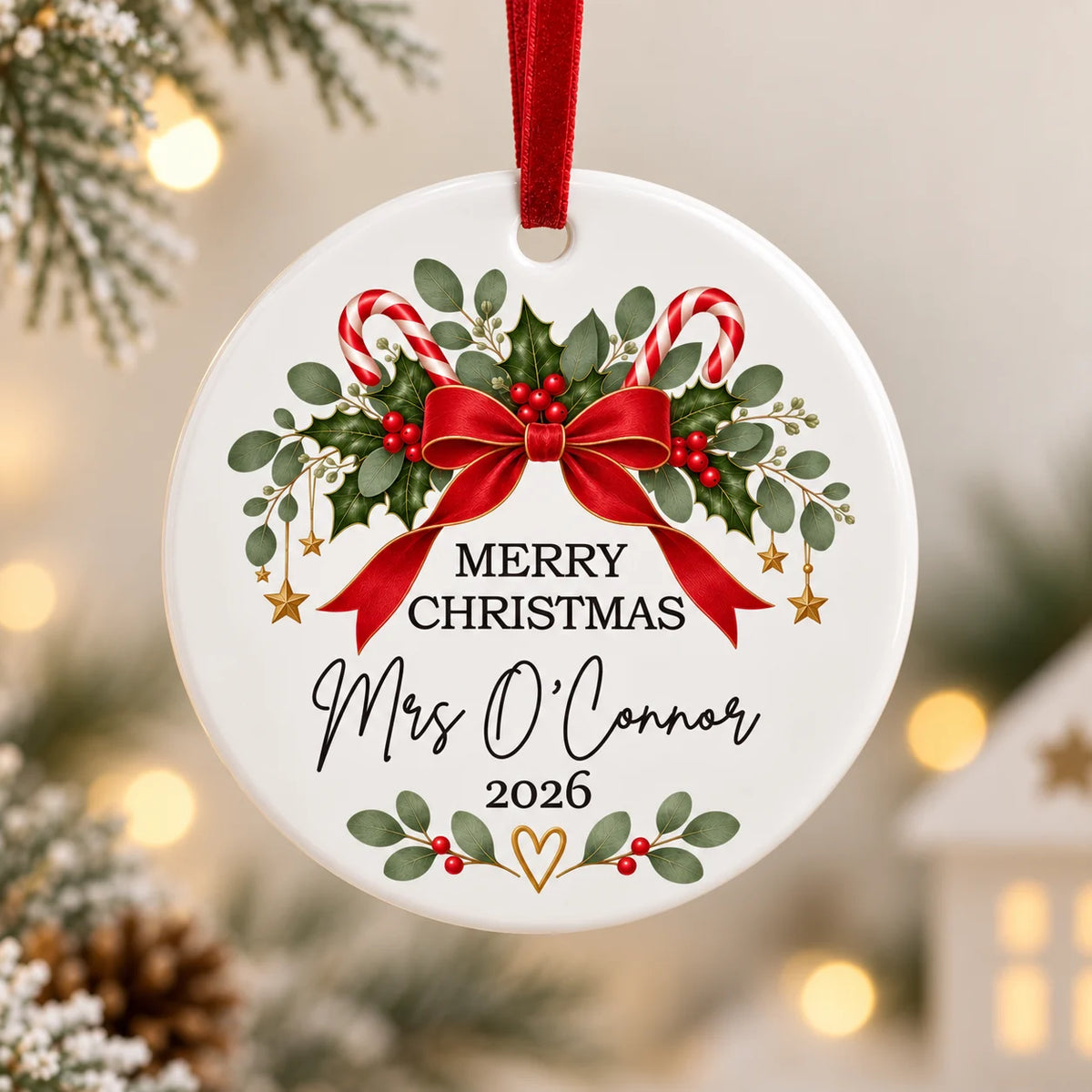 Personalised teacher Christmas ceramic decoration with Mrs O'Connor name, festive red bow, holly and red velvet ribbon