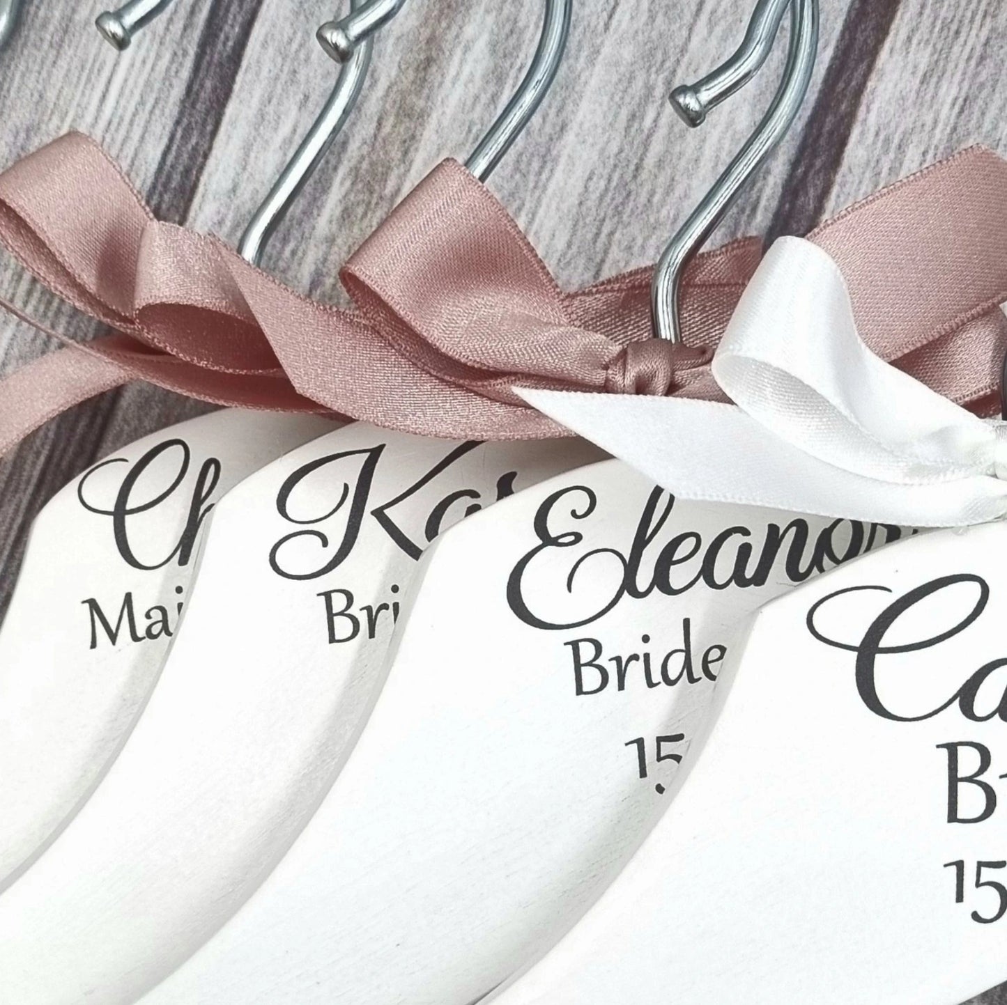 Set of personalised wedding dress hangers for bride and bridesmaids with ribbon bows