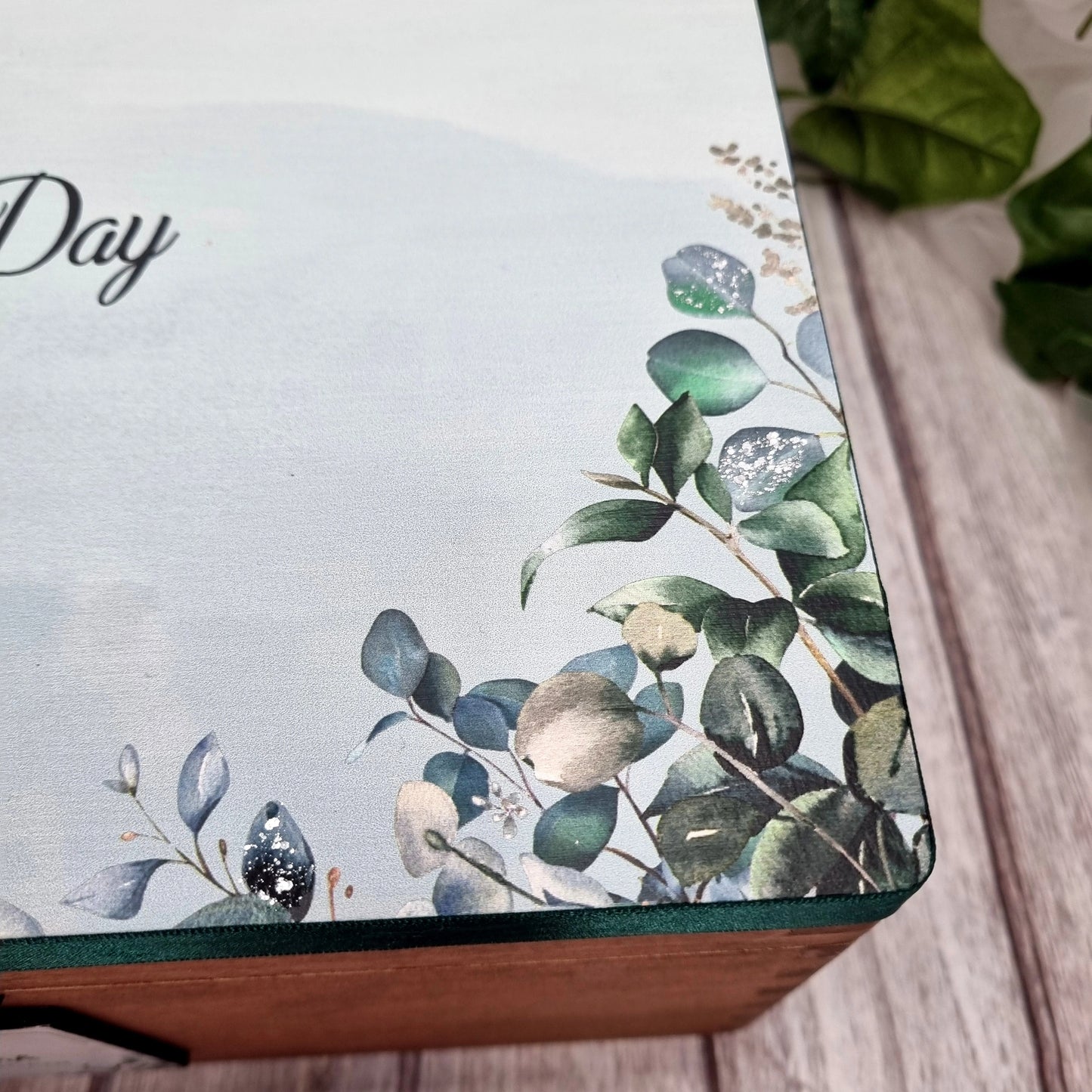 Wooden wedding memory box personalised with couple names shown in natural wood finish on neutral background