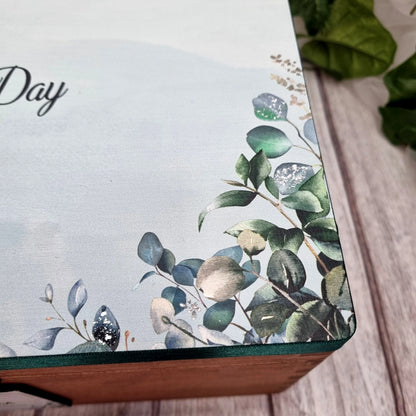 Wooden wedding memory box personalised with couple names shown in natural wood finish on neutral background