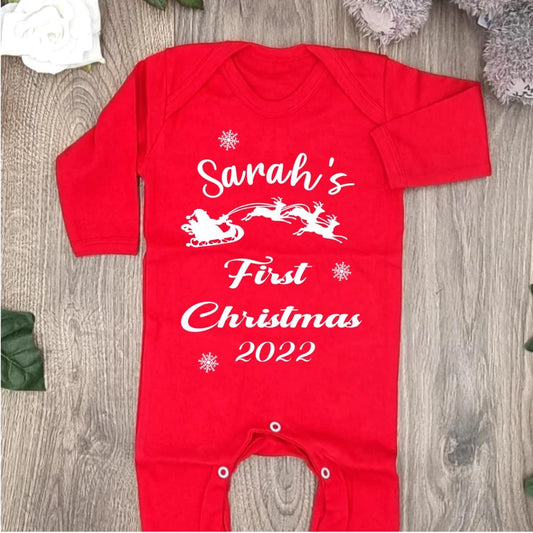 Red baby's first christmas babygro with white font and picture of santa and the reindeer