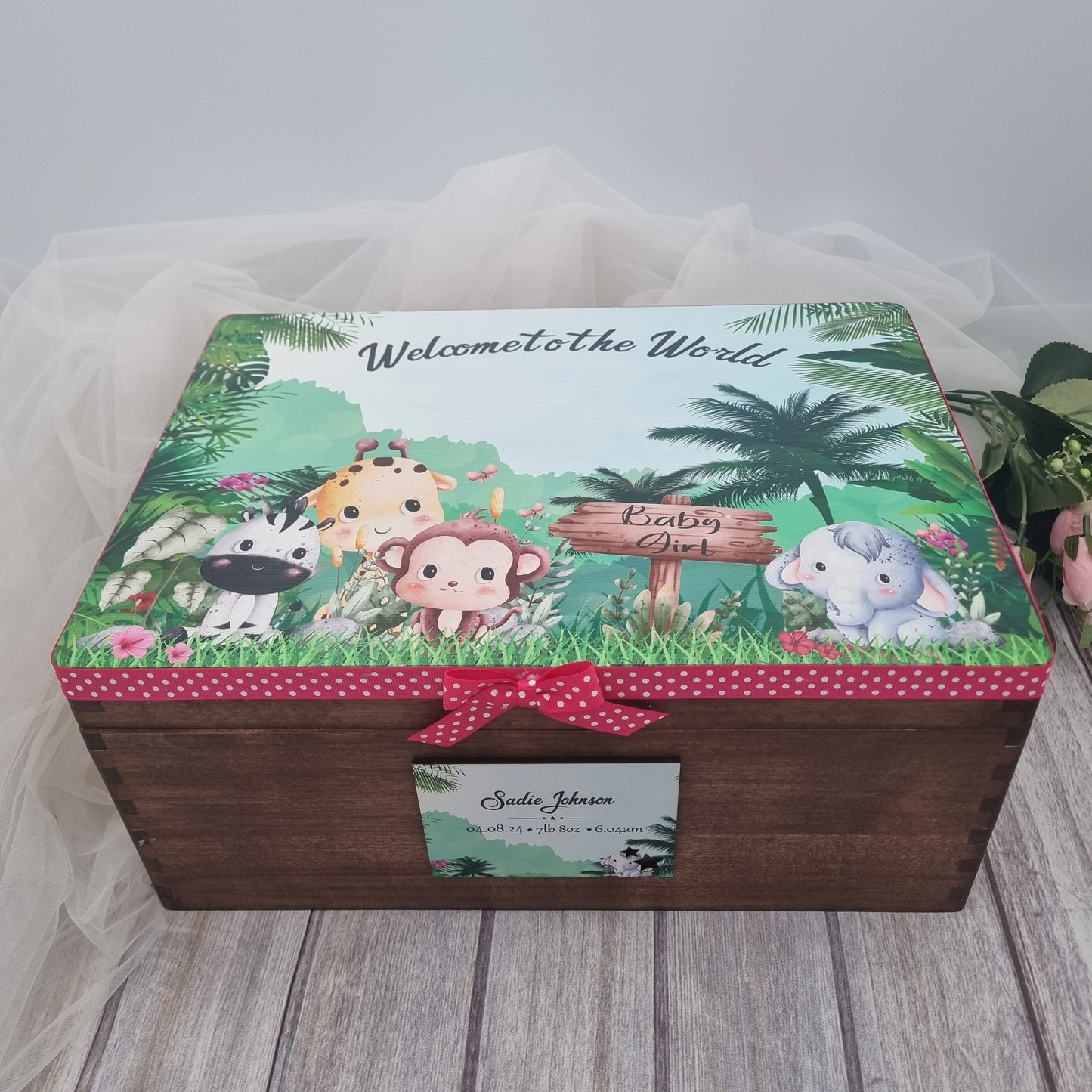 Jungle safari themed baby girl keepsake box featuring elephant, monkey and giraffe illustration with personalised name plaque on wooden box.