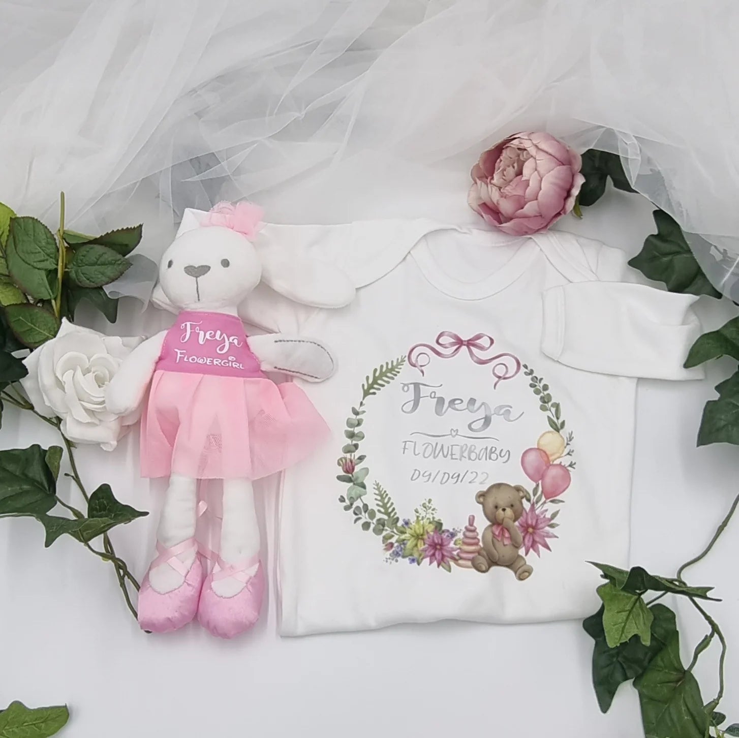 Personalised white Flowerbaby babygrow with teddy bear and pastel floral print, with baby's details, 
designed, printed and finished in Co. Meath, Ireland.