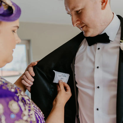 White wedding handkerchief tied with personalised satin ribbon featuring bride and groom names