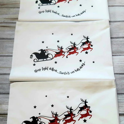 White Christmas eve pillowcase with black silhouette of Santa Sleigh and red glitter with personalised poem