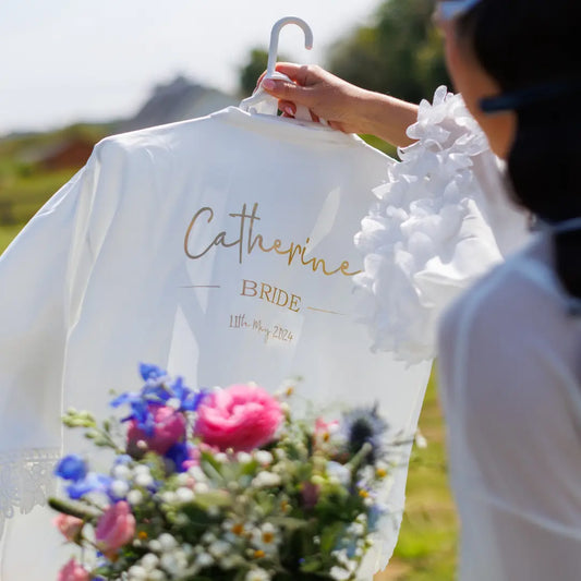 Personalised white bridal robe with gold lettering showing bride’s name and wedding date, designed and printed by HanaLee Studios in Co. Meath, Ireland