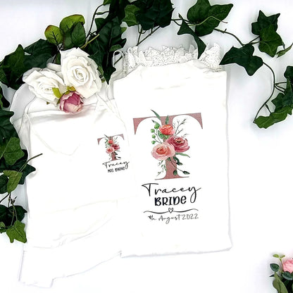 Personalised white satin bride robe with floral initial “T” and lace trim, printed and finished in Ireland by HanaLee Studios.