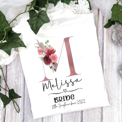 Personalised bride robe in white satin with floral initial “M” design and lace detailing – Irish designed and printed by HanaLee Studios.