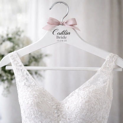 Personalised bride wedding dress hanger with name Caitlin and wedding date holding lace bridal gown