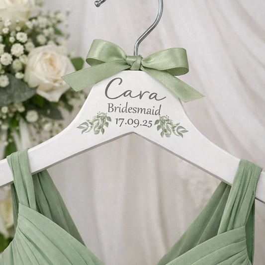 Personalised bridesmaid hanger with sage green ribbon hanging on sage green bridesmaid dress
