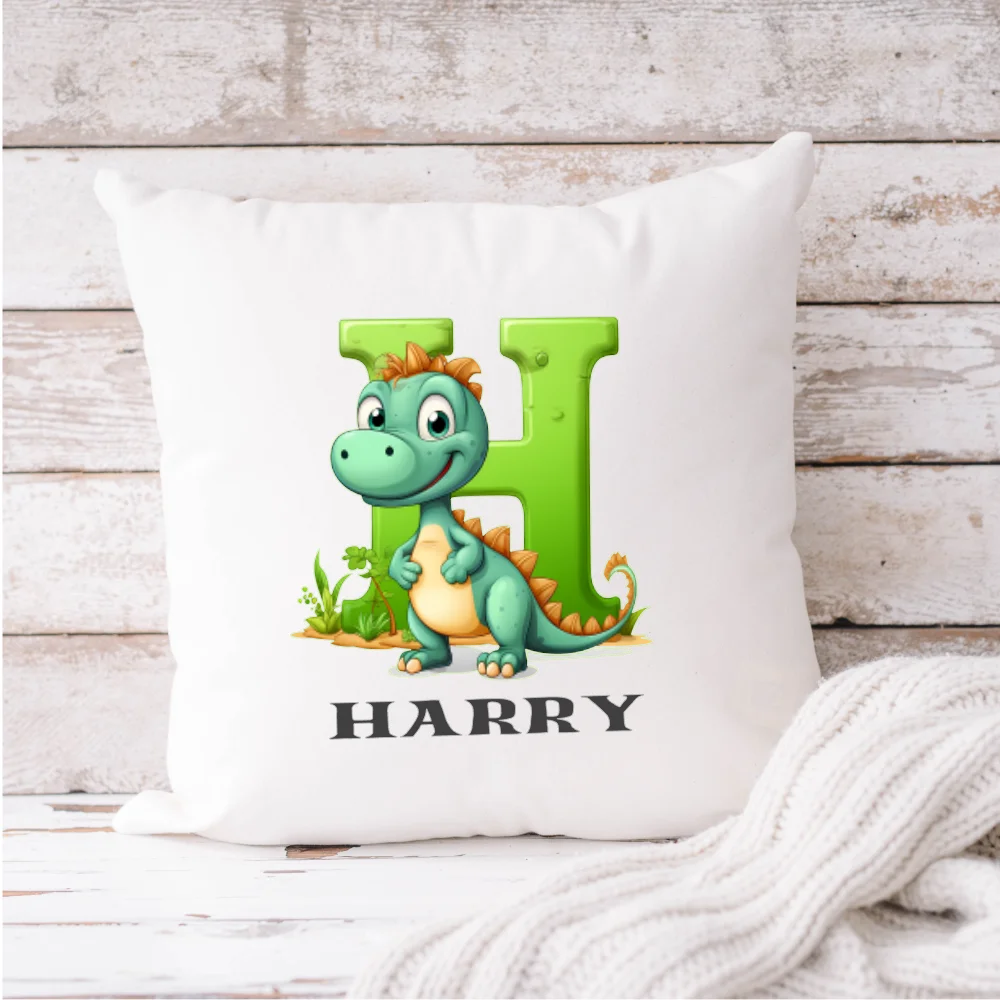 Personalised dinosaur cushion with the name Harry – green dinosaur design on white cushion, Irish-made