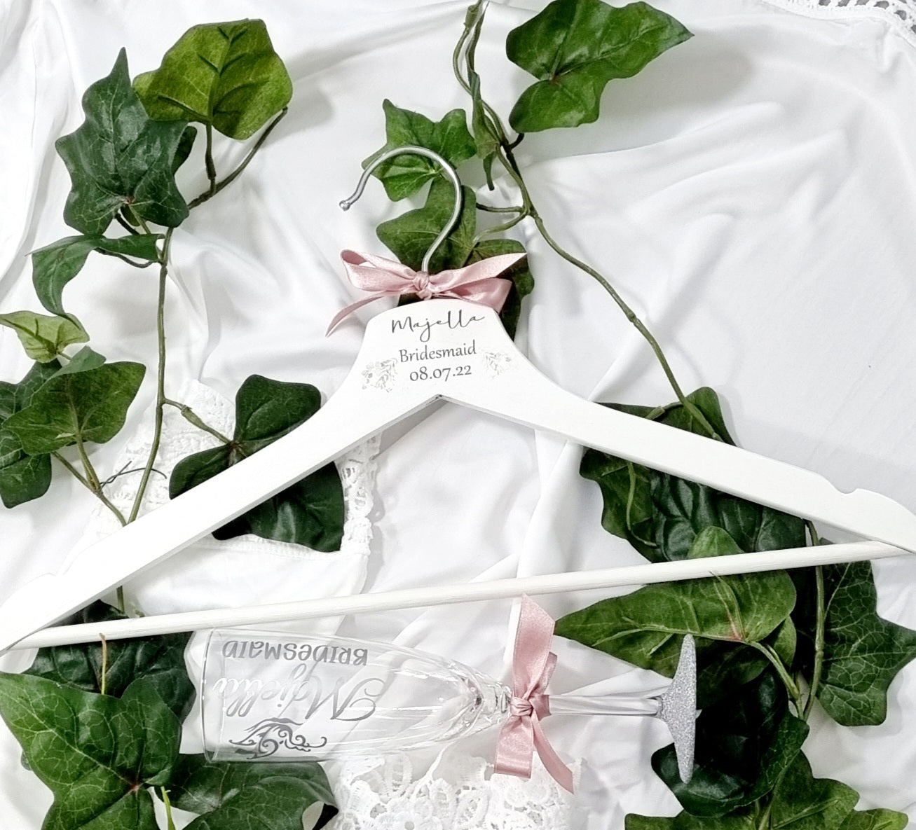 HanaLee's beautiful white wooden hanger with eucalyptus printed design and personalised with name title and date of the wedding. Each hanger is finished off with choice of ribbon colour