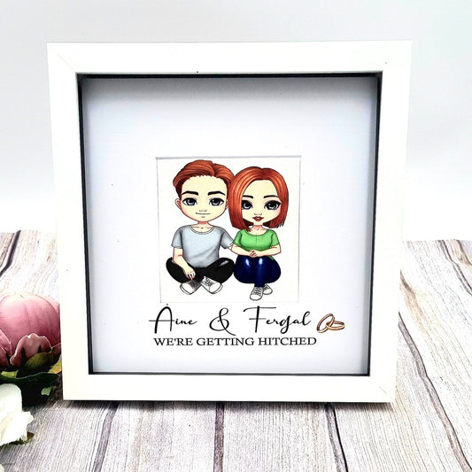 White wooden HanaLee frame with beautiful cartoon character couple with names and we're getting married message