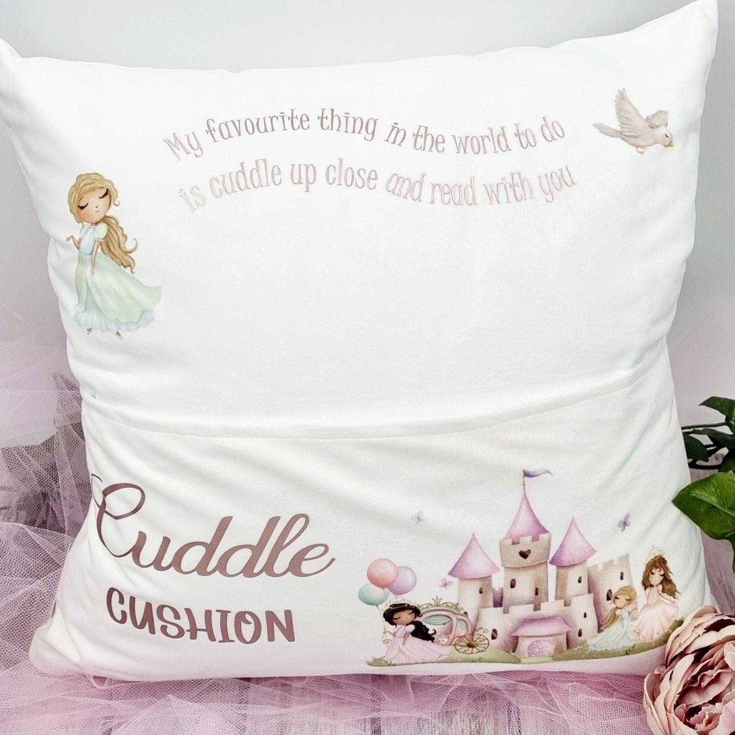 This is a white cushion with a pock at the front for children to put in a book. It is printed with a princess palace design on the front and  princess at the Top. The text reads - my favourite thing in the world to do is cuddle up close and read with you. 