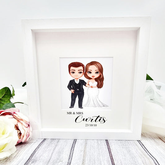 Beautiful white wooden gift frame for wedding with cartoon print of the wedding couple and name and date underneath