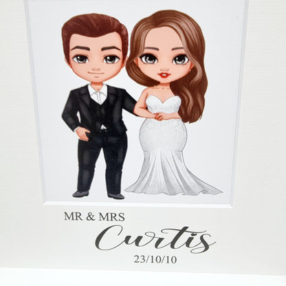 Beautiful white wooden gift frame for wedding with cartoon print of the wedding couple and name and date underneath