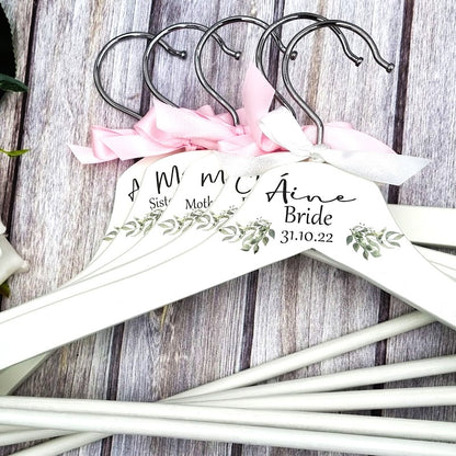 HanaLee's beautiful white wooden hanger with eucalyptus printed design and personalised with name title and date of the wedding. Each hanger is finished off with choice of ribbon colour