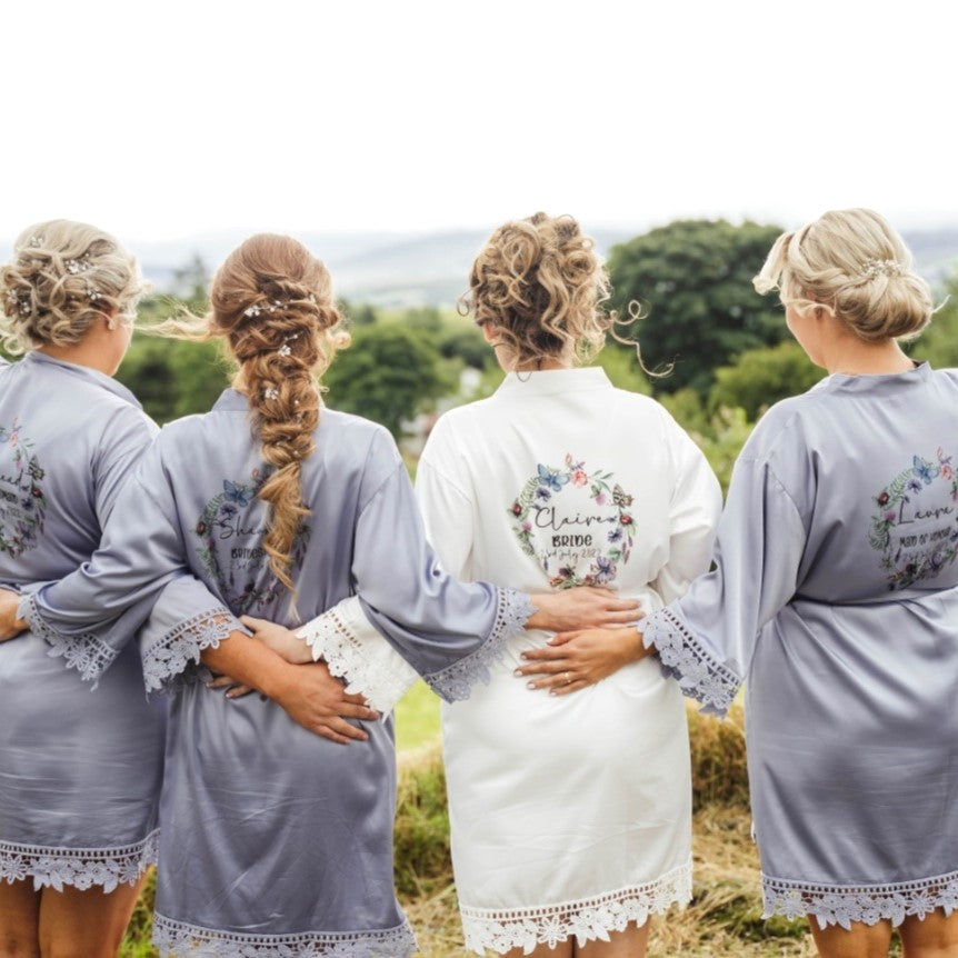 White and dusty blue robes with matching butterfly wreath design robes personalised with bride and bridesmaids names and titles